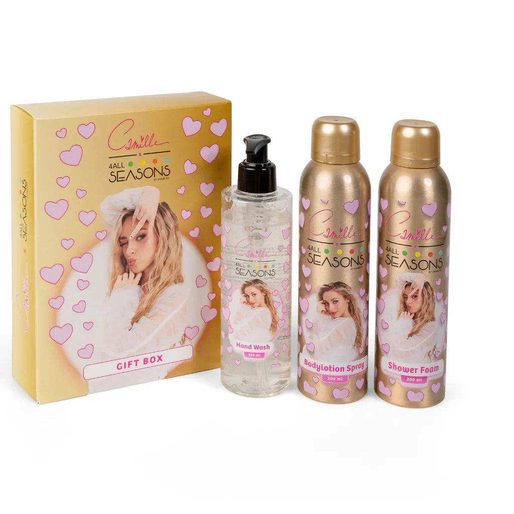 Camille Gold geschenkdoos met roze hartjes naast handzeep, bodylotion spray en doucheschuim in goudkleurige verpakking