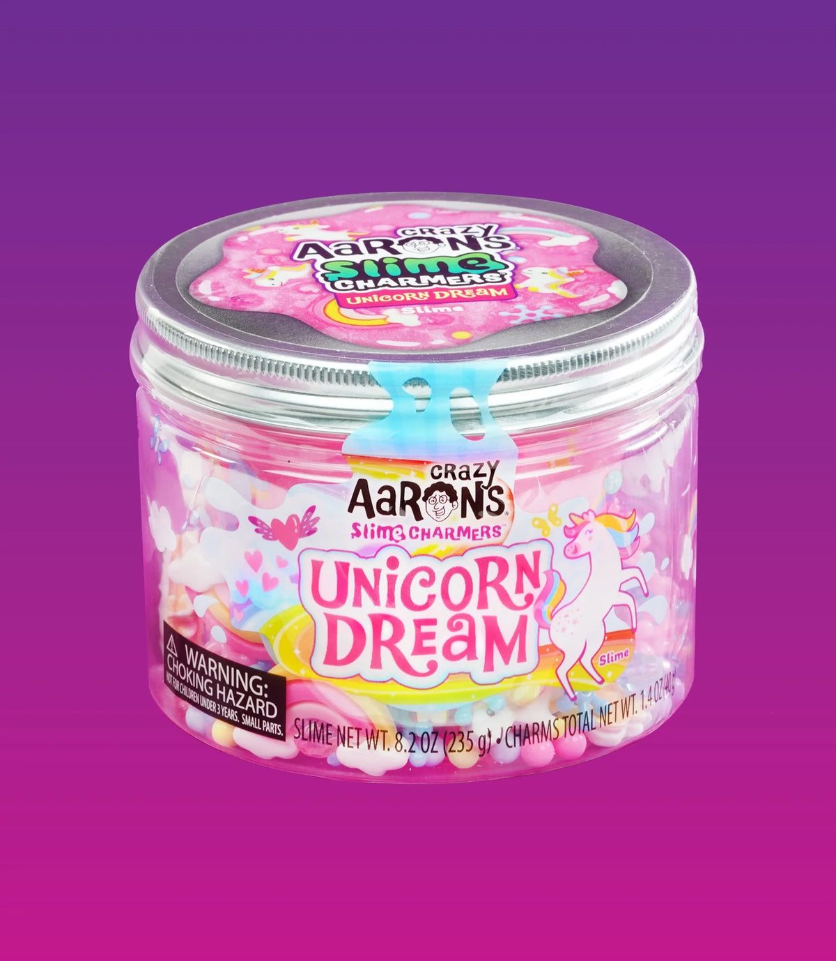 Gesloten pot Crazy Aarons Slime Charmers Unicorn Dream met zilverkleurig deksel tegen een paarse achtergrond.