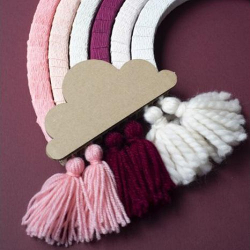 Detail van de regenboog Mono Roze met een kartonnen wolk en roze, bordeauxrode en witte kwastjes
