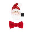 Twee haarclips in kerstthema: een kerstman met rode glittermuts en witte baard, en een rode glitterstrik.