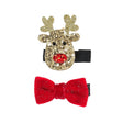 Twee haarclips met een goudkleurig glitterrendier met rode neus en een rode glitterstrik op zwarte clips.