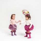 Twee kinderen met tutu rokjes in paars en roze, bij een ballon; rechts het Tutu Bloomer Heather Pink rokje.